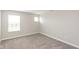 Bright, neutral bedroom with plush carpet, two windows, and electrical outlets at 9709 Tampico Chase, Fishers, IN 46040