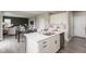 Bright open-concept kitchen with a large island, modern appliances, and an adjacent dining and living area at 9709 Tampico Chase, Fishers, IN 46040