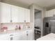 Bright kitchen with white cabinets, stainless steel appliances, and modern backsplash at 9709 Tampico Chase, Fishers, IN 46040