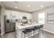 Modern kitchen featuring stainless steel appliances, an island with barstool seating, and white cabinetry at 9709 Tampico Chase, Fishers, IN 46040