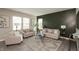 Cozy living room with two sofas, an accent wall, large windows, and a stylish area rug at 9709 Tampico Chase, Fishers, IN 46040