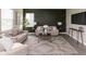Comfortable living room with sofas, accent wall, side tables, and a patterned rug for a welcoming ambiance at 9709 Tampico Chase, Fishers, IN 46040
