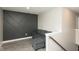 Modern living room features stylish accent wall, gray sofa, and wood-look flooring at 9709 Tampico Chase, Fishers, IN 46040