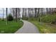 Paved nature trail winding through a serene wooded area with lush greenery at 9709 Tampico Chase, Fishers, IN 46040
