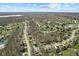 An aerial view of a neighborhood featuring homes, streets, trees, and water in the distance at 10145 Northwind Dr, Indianapolis, IN 46256