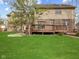 Large backyard with a wooden deck and grassy area at 10145 Northwind Dr, Indianapolis, IN 46256