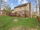 Large backyard with a wooden deck and grassy area at 10145 Northwind Dr, Indianapolis, IN 46256