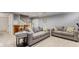 Finished basement with gray couches, stairway, and bar at 10145 Northwind Dr, Indianapolis, IN 46256
