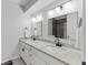 Bathroom with double sinks, granite countertop, and modern lighting at 10145 Northwind Dr, Indianapolis, IN 46256
