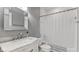 Bathroom with white marble vanity, brushed nickel hardware, tiled shower and gray walls at 10145 Northwind Dr, Indianapolis, IN 46256