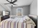 Bedroom featuring a ceiling fan, window with blinds, and a TV at 10145 Northwind Dr, Indianapolis, IN 46256
