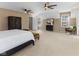 Open bedroom with two ceiling fans, two closets, window and seating at 10145 Northwind Dr, Indianapolis, IN 46256