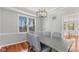 Bright dining room features hardwood floors, modern lighting, and natural light from a large window at 10145 Northwind Dr, Indianapolis, IN 46256