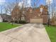 Two-story brick home featuring a two-car garage with basketball hoop on a large concrete driveway at 10145 Northwind Dr, Indianapolis, IN 46256