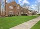 Charming two-story brick home with a well-manicured lawn, lush green grass, and walkway at 10145 Northwind Dr, Indianapolis, IN 46256