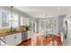 Eat-in kitchen area with stainless steel dishwasher, white cabinets, and access to the back deck at 10145 Northwind Dr, Indianapolis, IN 46256