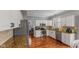 Well-lit kitchen featuring stainless steel appliances, tile backsplash, and hardwood flooring at 10145 Northwind Dr, Indianapolis, IN 46256