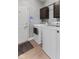 Practical laundry room with modern washer and dryer units, storage cabinets and tile flooring at 10145 Northwind Dr, Indianapolis, IN 46256