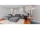 Comfortable living room featuring a plush grey sectional, ottoman, and hardwood flooring at 10145 Northwind Dr, Indianapolis, IN 46256
