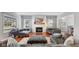 Cozy living room with a brick fireplace, plush seating, and beautiful hardwood floors at 10145 Northwind Dr, Indianapolis, IN 46256