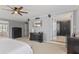 A luxurious main bedroom with elegant furniture, a ceiling fan, and an adjacent walk-in closet at 10145 Northwind Dr, Indianapolis, IN 46256