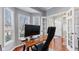 Bright home office with hardwood floors, neutral walls, and a large black computer monitor at 10145 Northwind Dr, Indianapolis, IN 46256