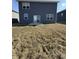 View of backyard with dark siding, sliding glass door and windows and a patio at 10950 N Heirloom Dr, Monrovia, IN 46157