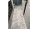 Bathroom with marble floor tiles, dark cabinets, and a doorway to the toilet and shower area at 10950 N Heirloom Dr, Monrovia, IN 46157