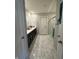 Modern bathroom with double sinks and marble tile, and a glass enclosed shower at 10950 N Heirloom Dr, Monrovia, IN 46157