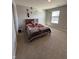 Cozy bedroom features a comfortable bed with a soft blanket and natural light from a window at 10950 N Heirloom Dr, Monrovia, IN 46157