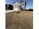 Two story home boasts vinyl siding, stone accents, two car garage, and a long concrete driveway at 10950 N Heirloom Dr, Monrovia, IN 46157