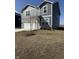 Two story home boasts vinyl siding, stone accents, two car garage, and a long concrete driveway at 10950 N Heirloom Dr, Monrovia, IN 46157