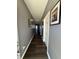Hallway with dark wood floors, grey walls, white trim, and two hanging pictures at 10950 N Heirloom Dr, Monrovia, IN 46157