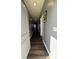 Hallway with dark wood floors, grey walls, white trim, and two hanging pictures at 10950 N Heirloom Dr, Monrovia, IN 46157