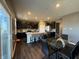 Open-concept kitchen and dining area with a center island, modern dark cabinets, and stainless steel appliances at 10950 N Heirloom Dr, Monrovia, IN 46157