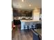 Bright kitchen with an island with barstools, dark wood cabinets, and stainless steel appliances at 10950 N Heirloom Dr, Monrovia, IN 46157