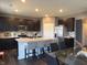 View of the kitchen with stainless steel appliances, a tile backsplash, and a kitchen island with bar seating at 10950 N Heirloom Dr, Monrovia, IN 46157