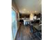This kitchen and dining area features an island, a glass table, and dark cabinets throughout at 10950 N Heirloom Dr, Monrovia, IN 46157
