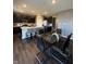 This contemporary kitchen features dark cabinetry, a large island, and a dining area with a glass table and chairs at 10950 N Heirloom Dr, Monrovia, IN 46157