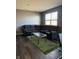 Living room featuring a large gray sofa, a clear topped coffee table, and dark wood floors at 10950 N Heirloom Dr, Monrovia, IN 46157