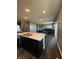 Open layout features a granite countertop island that overlooks the dining and living areas at 10950 N Heirloom Dr, Monrovia, IN 46157