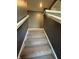 Carpeted stairway featuring a white railing and neutral-toned walls at 10950 N Heirloom Dr, Monrovia, IN 46157