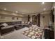 Spacious basement with a large sectional sofa and stylish decor at 11458 Falling Water Way, Fishers, IN 46037