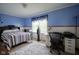 Bright bedroom with modern furnishings, including a desk and queen-size bed at 11458 Falling Water Way, Fishers, IN 46037