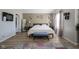 Bright bedroom featuring wooden floors, decorative lamps and wall art, with a comfy rug adding a splash of color at 11458 Falling Water Way, Fishers, IN 46037