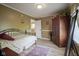 Inviting bedroom with wooden floors, complemented by a large wooden dresser and ample natural light at 11458 Falling Water Way, Fishers, IN 46037