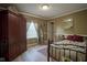 Cozy bedroom with warm wall colors, featuring a large window, wood floors and vintage-inspired decor at 11458 Falling Water Way, Fishers, IN 46037