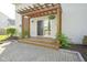 Wooden deck with a pergola creates an inviting outdoor space, enhanced by blooming vines and a paver patio at 11458 Falling Water Way, Fishers, IN 46037
