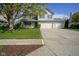 Two-story home with a covered porch, a three-car garage and a well-maintained lawn at 11458 Falling Water Way, Fishers, IN 46037