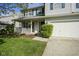 Well-manicured lawn leads up to a house with a charming porch and a convenient three-car garage at 11458 Falling Water Way, Fishers, IN 46037